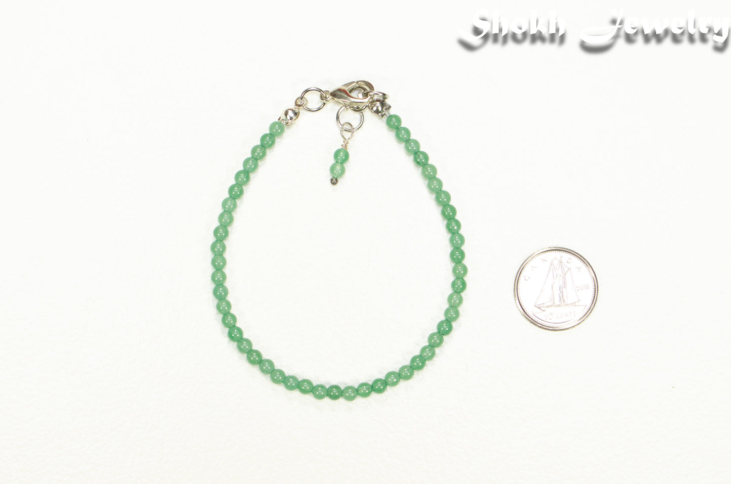3mm Green Aventurine Beaded Bracelet beside a dime.