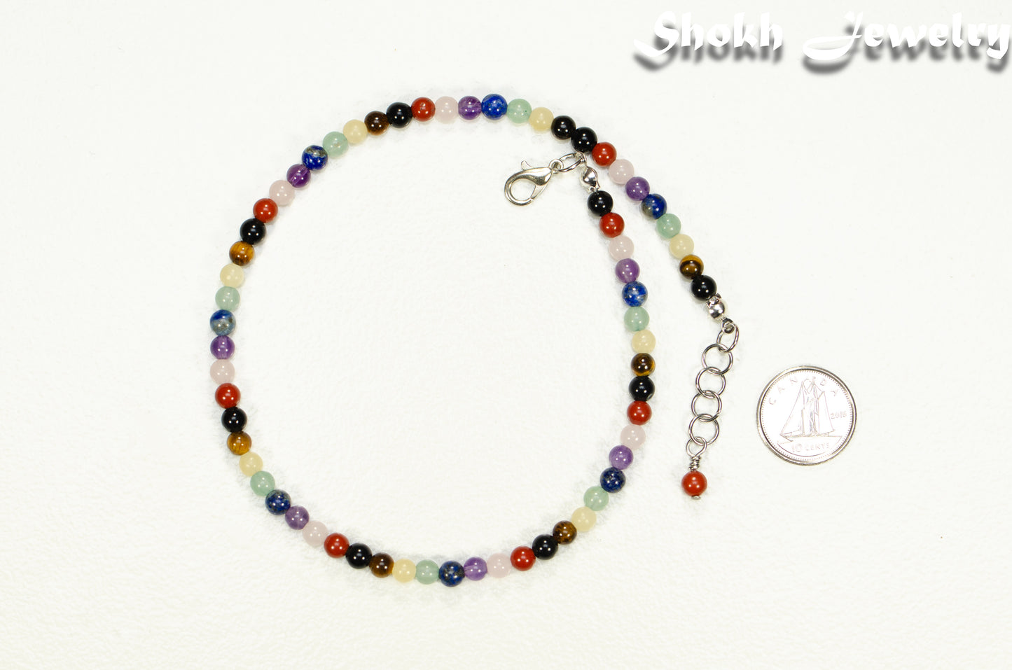 4mm Chakra Gemstone Choker Necklace beside a dime.