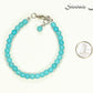 6mm Turquoise Howlite Beaded Bracelet beside a dime.