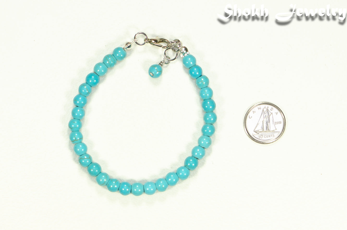 6mm Turquoise Howlite Beaded Bracelet beside a dime.