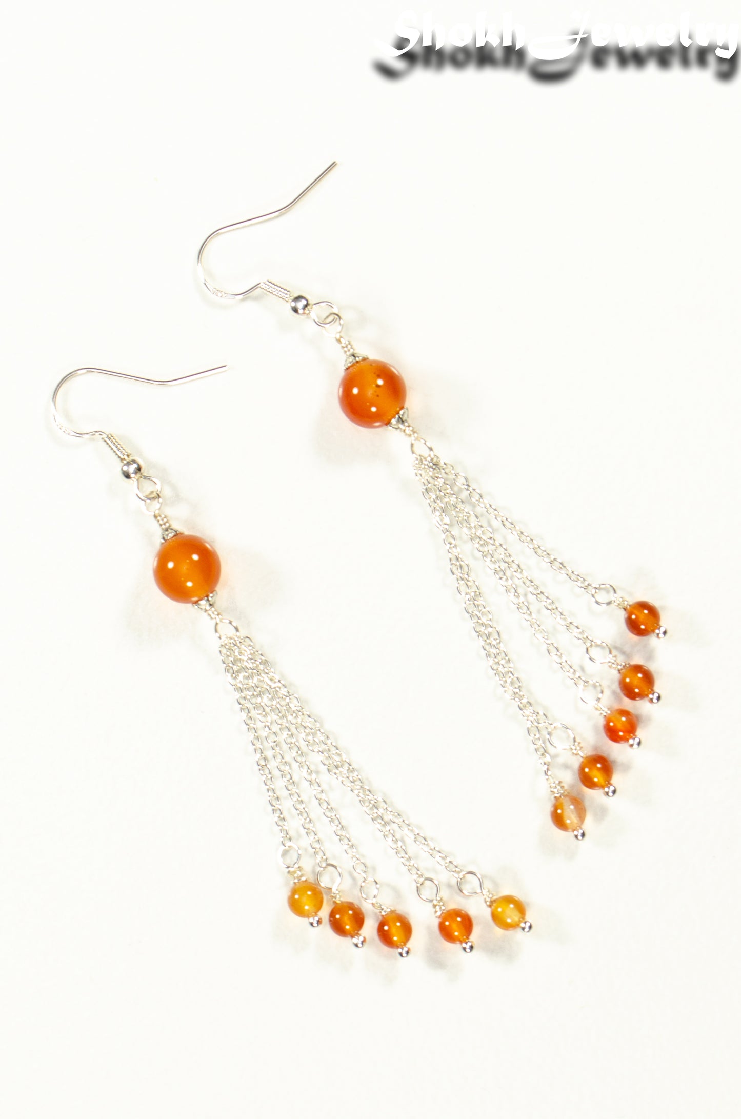Top view of Cascading Carnelian Crystal Drop Earrings.