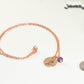 Rose Gold Plated February Birth Flower Necklace with Amethyst Birthstone Pendant beside a dime.
