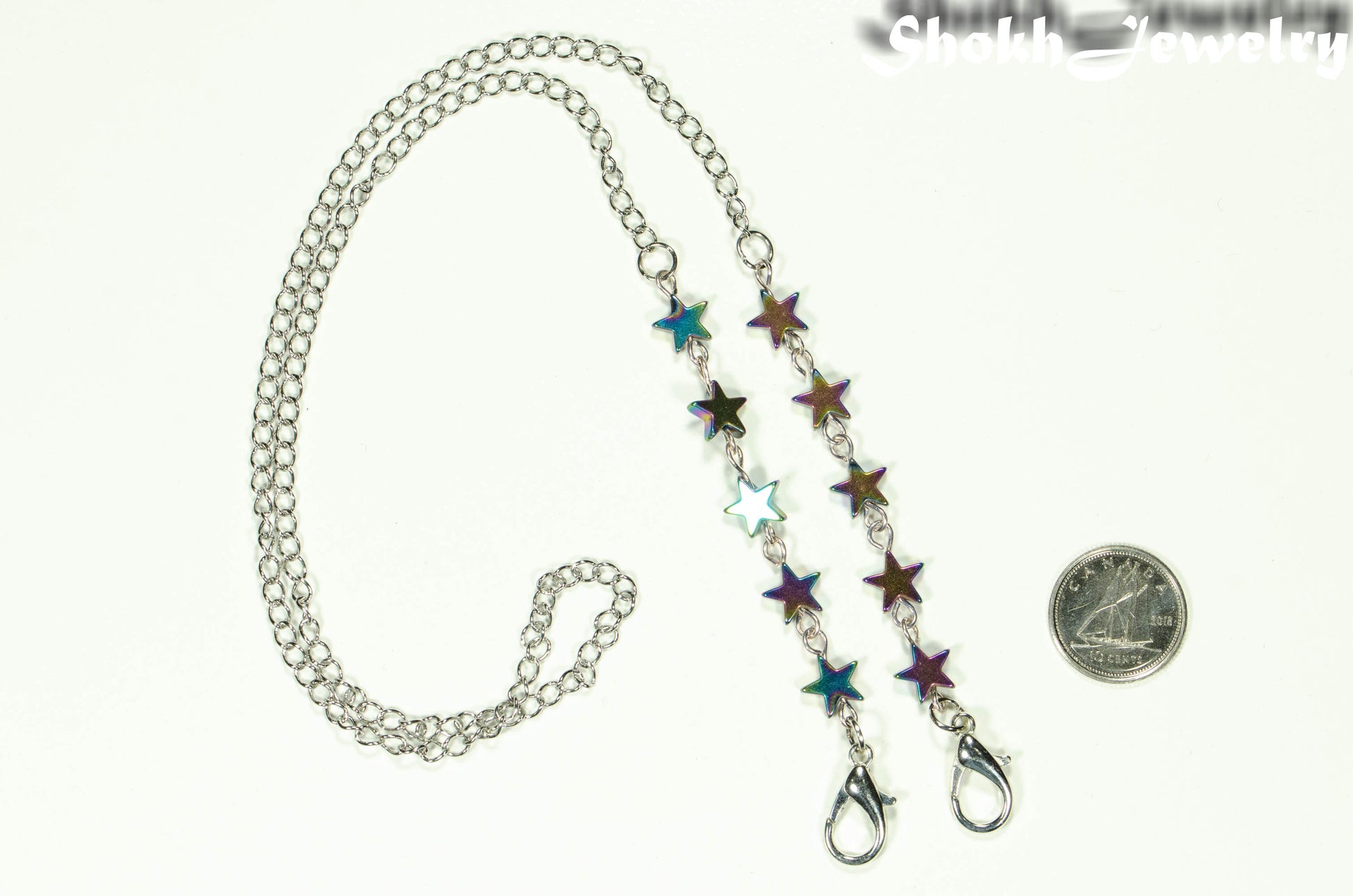 Rainbow Hematite Star Eyeglass Chain beside a dime.