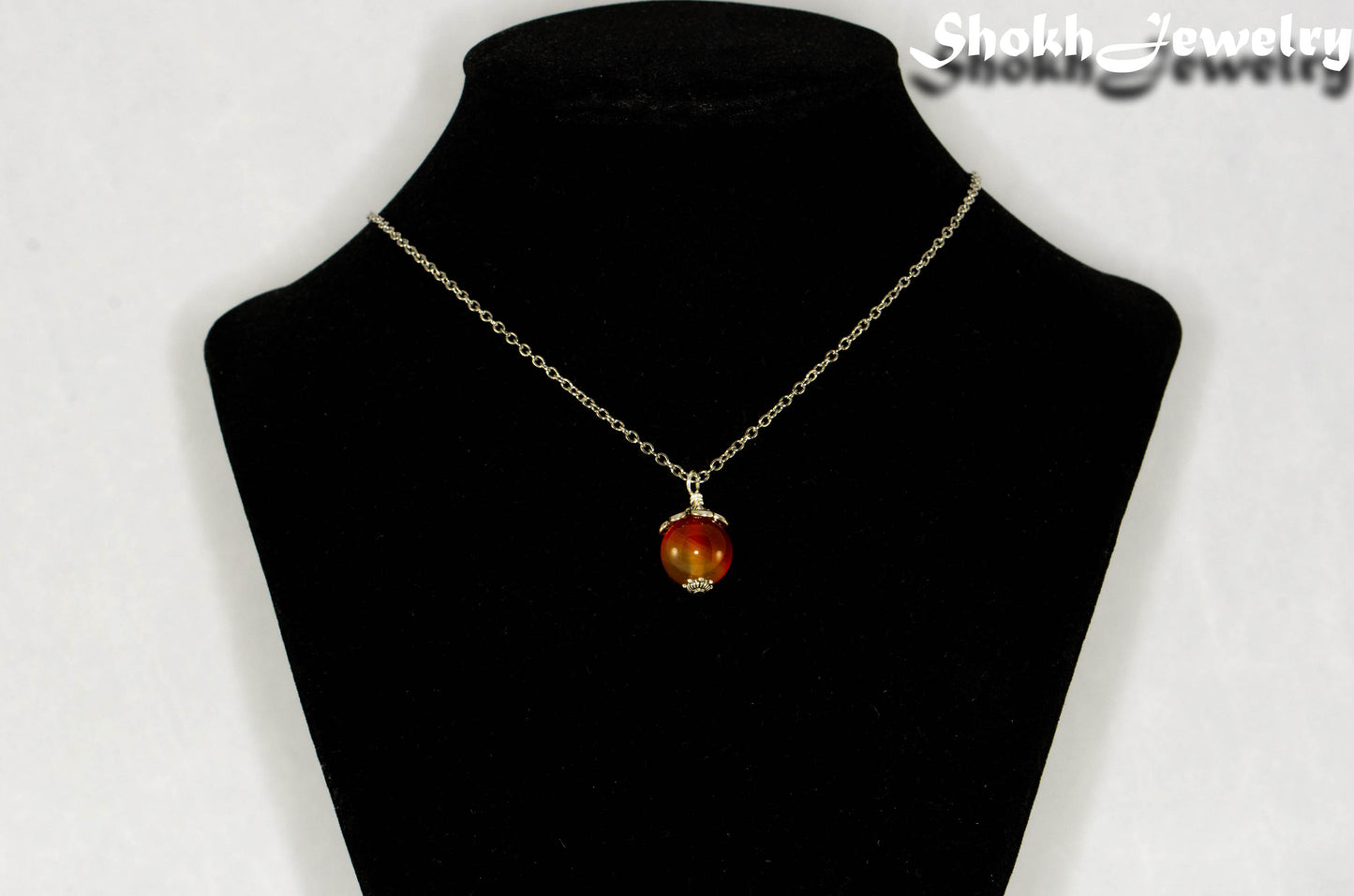 12mm Carnelian Pendant Necklace displayed on a bust.