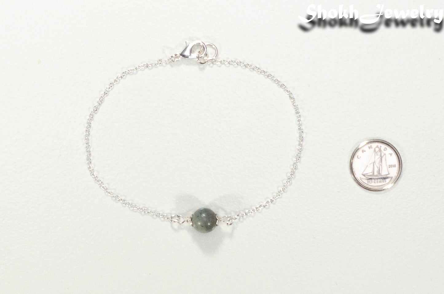 Minimal Labradorite Bracelet beside a dime.