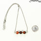 Carnelian and Dainty Chain Choker Necklace with a clasp beside a dime.