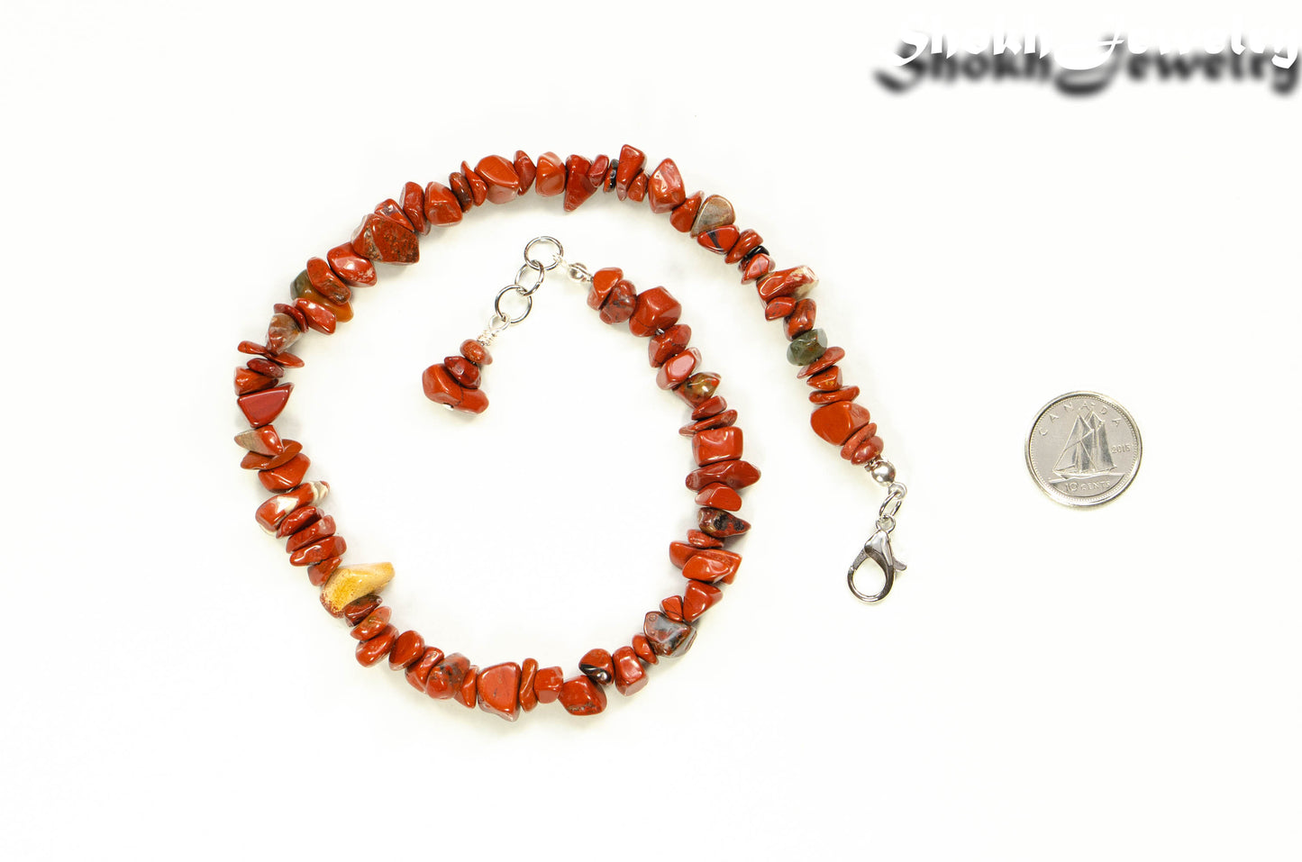 Natural Red Jasper Crystal Chip Choker Necklace beside a dime