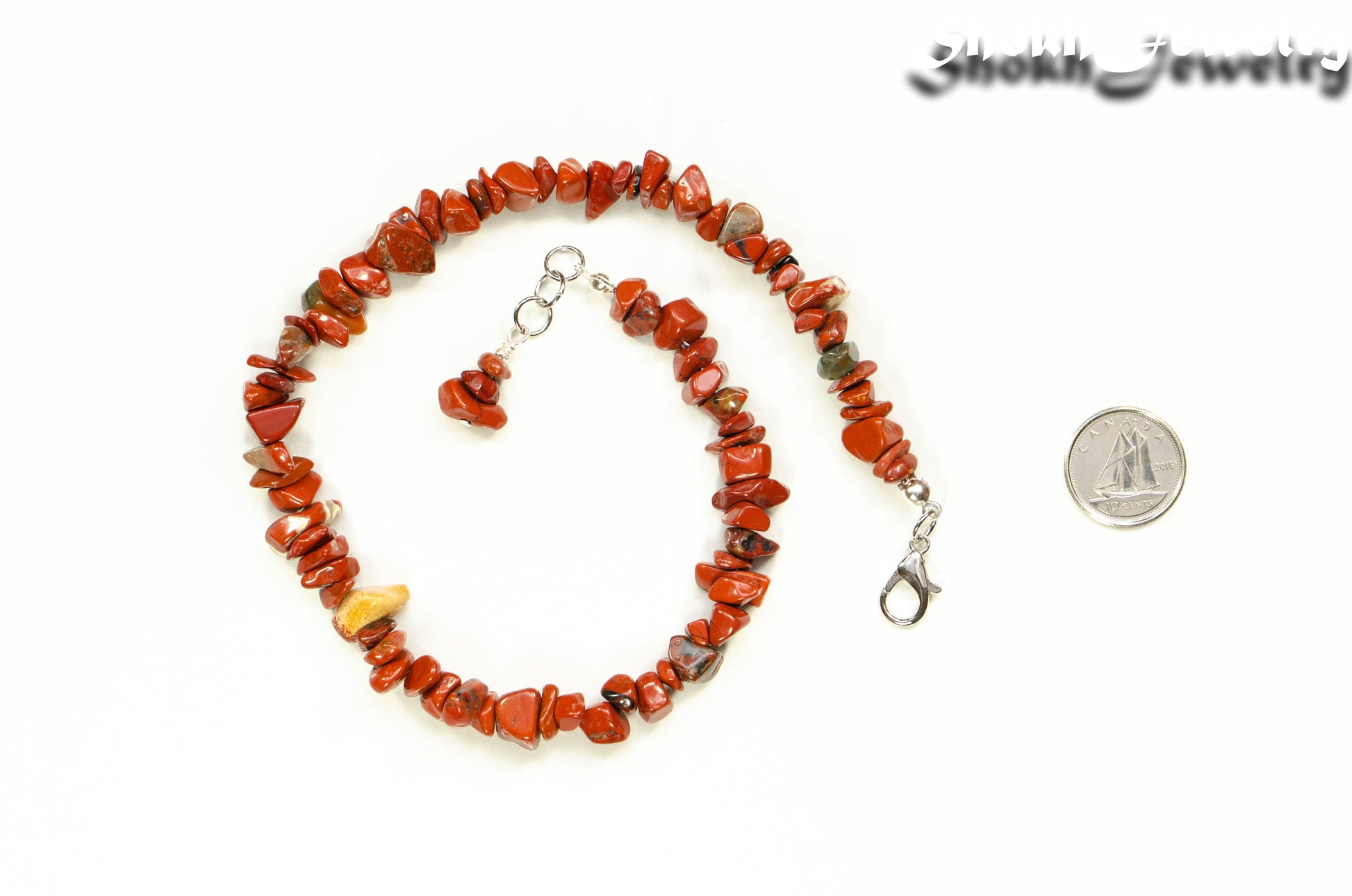 Natural Red Jasper Crystal Chip Choker Necklace beside a dime