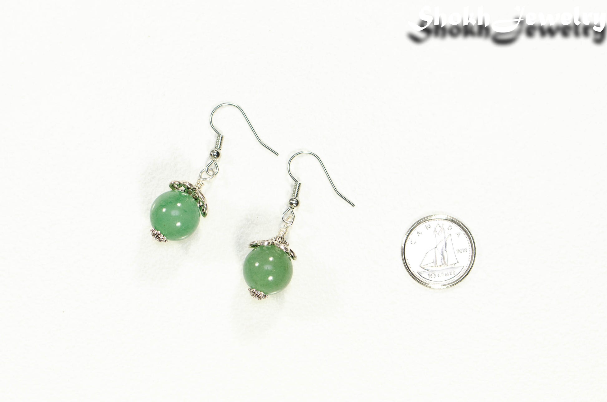12mm Natural Green Aventurine Crystal Earrings beside a dime