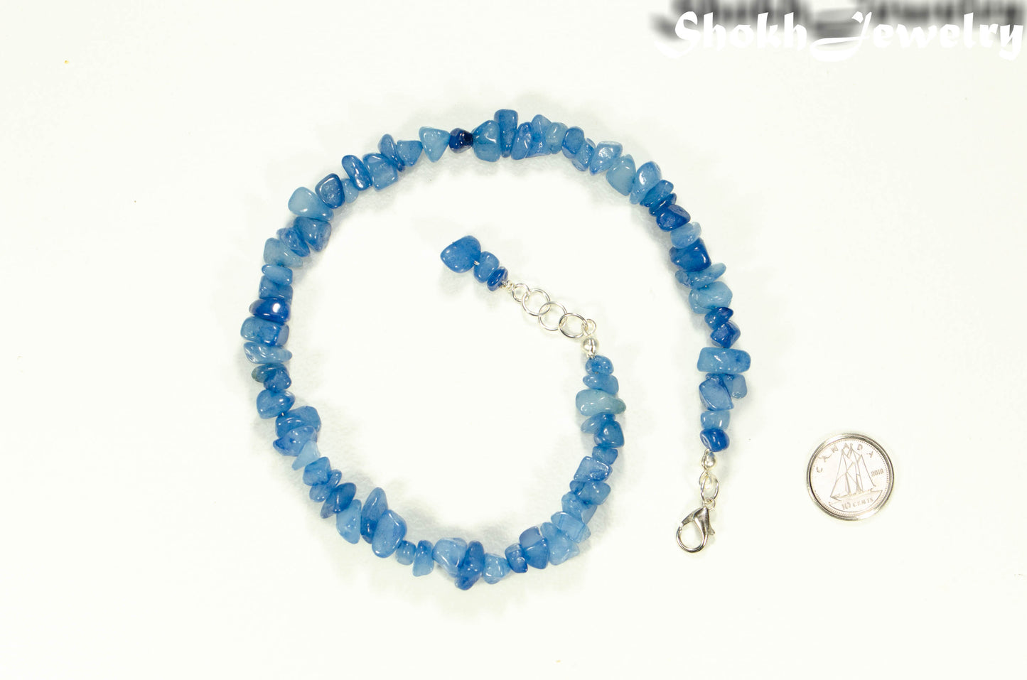 Natural Blue Quartzite Crystal Chip Choker Necklace beside a dime